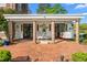 Covered patio features brick columns, a swing and sitting area with an idyllic outdoor space at 3542 Bason Rd, Mebane, NC 27302