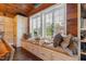 Inviting window seat with built-in storage, plush cushions, and a view of the landscaped yard at 3542 Bason Rd, Mebane, NC 27302