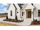 Close up of a house's entrance, featuring beautiful landscaping and an elegant front door at 3941 Wendell Blvd, Wendell, NC 27591