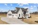 Beautiful exterior showcasing a well-manicured lawn, attached garage, and a stylish front entrance at 3941 Wendell Blvd, Wendell, NC 27591