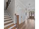 A light-filled home foyer featuring hardwood floors, stairs, and modern lighting fixtures at 3941 Wendell Blvd, Wendell, NC 27591