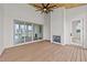 An elegant sun room with a fireplace, sliding doors, wood flooring, and a ceiling fan at 3941 Wendell Blvd, Wendell, NC 27591