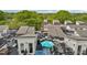 Aerial view of rooftop terraces, with dining sets and umbrellas, surrounded by lush trees at 400 W Rosemary St # 104, Chapel Hill, NC 27516