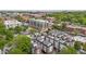 An aerial view showcases a neighborhood with modern apartment buildings and mature trees in an urban setting at 400 W Rosemary St # 104, Chapel Hill, NC 27516