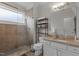 Well-lit bathroom featuring a glass shower, granite countertops, white cabinets, and a decorative storage unit at 400 W Rosemary St # 104, Chapel Hill, NC 27516