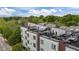 Modern townhome exterior with rooftop terraces, black railings, and brick accents at 400 W Rosemary St # 104, Chapel Hill, NC 27516
