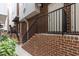 Brick townhome entrances with black railings and landscaped walkway at 400 W Rosemary St # 104, Chapel Hill, NC 27516