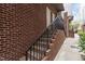Brick townhome entrance stairs with black metal railing at 400 W Rosemary St # 104, Chapel Hill, NC 27516