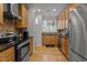 Well-equipped kitchen with stainless steel appliances and wood cabinetry at 400 W Rosemary St # 104, Chapel Hill, NC 27516