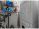 The laundry room has shelving for storage and a stacked washer and dryer set at 400 W Rosemary St # 104, Chapel Hill, NC 27516