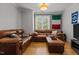 Comfortable living room with hardwood floors, leather sofas, and natural light from the window at 400 W Rosemary St # 104, Chapel Hill, NC 27516