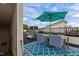 Rooftop deck with dining set, teal umbrella, grill and access to building's rooftop features at 400 W Rosemary St # 104, Chapel Hill, NC 27516