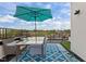 Inviting rooftop deck with dining area, outdoor umbrella, patterned rug, and city views at 400 W Rosemary St # 104, Chapel Hill, NC 27516