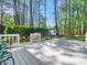 A backyard deck featuring outdoor seating and views of a private, tree-lined yard with storage shed at 403 Mayodan Dr, Cary, NC 27511
