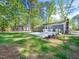 Expansive backyard with a white deck, offering serene views of the surrounding lush landscape at 403 Mayodan Dr, Cary, NC 27511