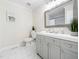 Updated bathroom featuring a gray vanity, framed mirror, and neutral wall decor, offering a serene atmosphere at 403 Mayodan Dr, Cary, NC 27511