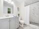 Modern bathroom with a gray vanity, shower with glass doors, and stylish fixtures, offering a sleek design at 403 Mayodan Dr, Cary, NC 27511