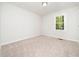Bright, empty bedroom with soft carpeting and a large window offering a clean, inviting space at 403 Mayodan Dr, Cary, NC 27511