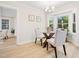 Dining room with light wood floors, a glass table, and views of the surrounding landscape at 403 Mayodan Dr, Cary, NC 27511