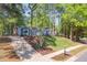 Charming home with a well-manicured lawn, a long driveway, and lush landscaping at 403 Mayodan Dr, Cary, NC 27511