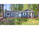 Inviting blue home with white trim, a light blue door, and manicured lawn at 403 Mayodan Dr, Cary, NC 27511