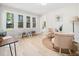 Bright living room with large windows, light floors, and stylish furnishings, perfect for relaxation and entertaining at 403 Mayodan Dr, Cary, NC 27511