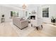 Cozy living room featuring neutral furniture, a brick fireplace, and light wood floors at 403 Mayodan Dr, Cary, NC 27511