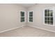 Bright bedroom with plush carpeting, neutral walls, and ample natural light from three large windows at 411 A Aversboro Rd, Garner, NC 27529