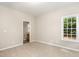 Cozy bedroom featuring plush carpeting, neutral walls, and a connecting bathroom at 411 A Aversboro Rd, Garner, NC 27529