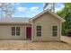 Tan home features large windows and a bright red front door at 411 A Aversboro Rd, Garner, NC 27529