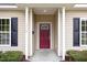 Close-up of the home's front door, showing the maroon door, black shutters and manicured landscaping at 411 A Aversboro Rd, Garner, NC 27529