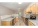 Bright kitchen boasts granite countertops, stainless steel appliances, and light wood cabinets at 411 A Aversboro Rd, Garner, NC 27529