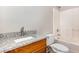 Full bath includes tub/shower combination, toilet, and vanity with granite countertop and brushed nickel faucet at 411 B Aversboro Rd, Garner, NC 27529