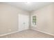 Carpeted bedroom with double closet doors and a window providing natural light at 411 B Aversboro Rd, Garner, NC 27529