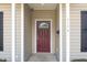 Inviting front door with glass detail framed by white columns and a well-lit entry way at 411 B Aversboro Rd, Garner, NC 27529