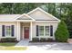 Charming single story home with tan siding, black shutters, a red door, and attractive landscaping at 411 B Aversboro Rd, Garner, NC 27529
