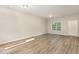 Bright living room with modern luxury vinyl plank flooring and a window overlooking the yard at 411 B Aversboro Rd, Garner, NC 27529