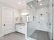Modern bathroom featuring a glass shower with white subway tile and a gray tile floor at 4237 Rowan St, Raleigh, NC 27609