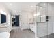 Spa-like bathroom with dual vanities, glass shower, and a stylish sliding barn door leading to closet at 4237 Rowan St, Raleigh, NC 27609