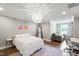 Bedroom with a unique light fixture, cozy seating area, and a dedicated workspace at 4237 Rowan St, Raleigh, NC 27609