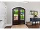 Elegant foyer featuring dark wood double doors, hardwood floors, and a charming accent table at 4237 Rowan St, Raleigh, NC 27609