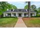 Charming white brick home featuring a welcoming front porch, perfect for relaxing and enjoying the outdoors at 4237 Rowan St, Raleigh, NC 27609