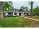 Inviting white brick home with a covered front porch and manicured lawn, creating a warm and welcoming curb appeal at 4237 Rowan St, Raleigh, NC 27609