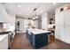 Well-lit kitchen showcasing an island with seating, stainless steel appliances, and modern finishes at 4237 Rowan St, Raleigh, NC 27609