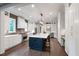 Bright kitchen with custom cabinets, large island with seating, and modern lighting fixtures at 4237 Rowan St, Raleigh, NC 27609