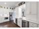 Bright kitchen area with custom cabinets, stainless steel appliances, and under counter lighting at 4237 Rowan St, Raleigh, NC 27609