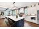 Gourmet kitchen featuring large island, stainless steel appliances, and custom white cabinetry at 4237 Rowan St, Raleigh, NC 27609