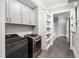 Well-organized laundry room with front-loading washer and dryer, and shelving with baskets at 4237 Rowan St, Raleigh, NC 27609