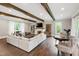 Spacious living room with hardwood floors, wood beams, fireplace and lots of natural light at 4237 Rowan St, Raleigh, NC 27609