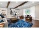 Inviting living room with wood beams, hardwood floors, a sectional sofa, and plenty of natural light at 4237 Rowan St, Raleigh, NC 27609